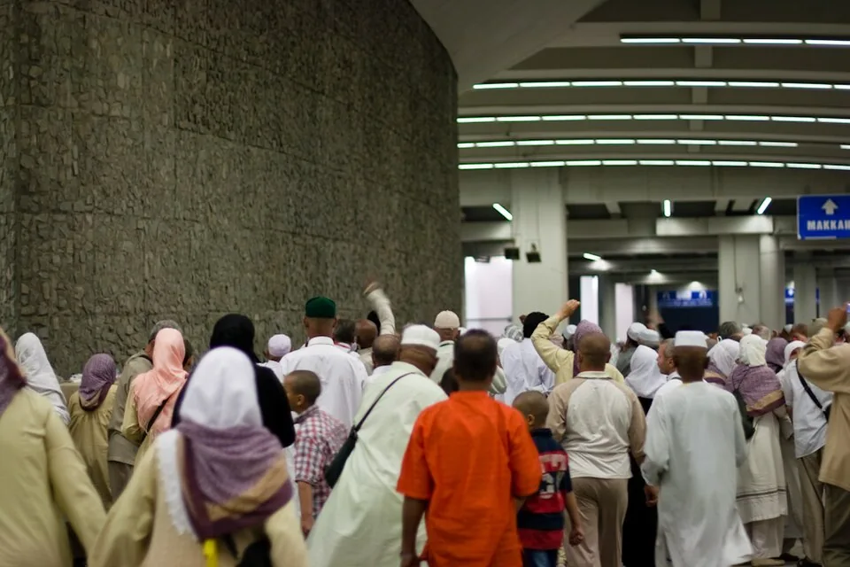 Pilgrims casting pebbles at a Jamarat wall in Mina during Hajj