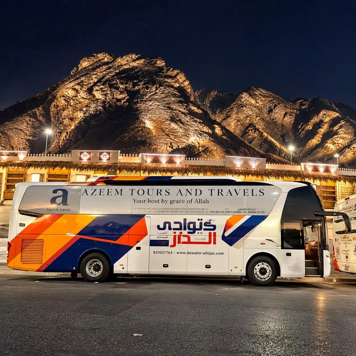 Mount Uhud glowing under floodlights at night, with the Azeem Tours and Travels bus parked beneath it in Madinah