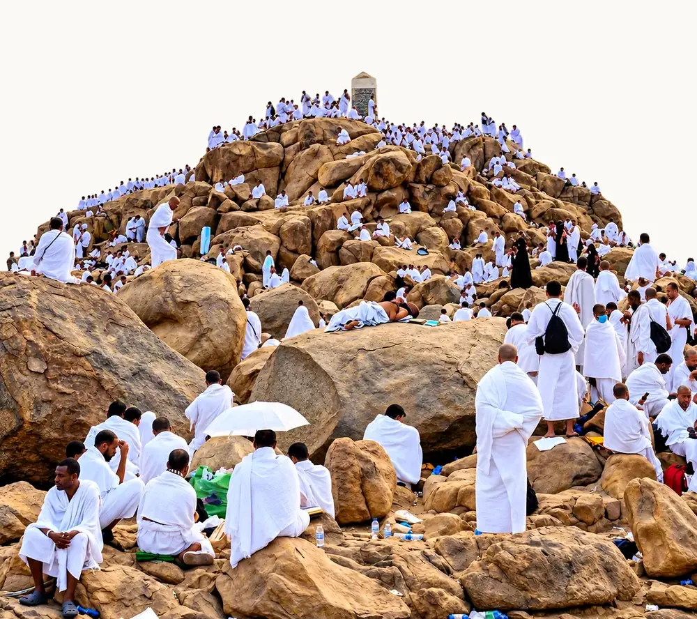 Pilgrims in white ihram gathered and resting on the granite rocks of Jabal Rahmah on the plain of Mount Arafat